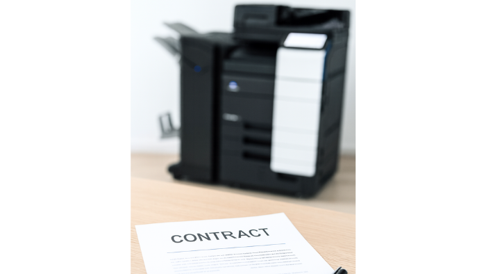 Contract for signature is seen on a desk in front of a copier for lease in Phoenix, Arizona