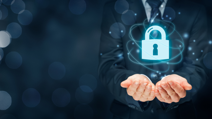 A padlock is seen in front of a business person. Copiers for law firms need security features